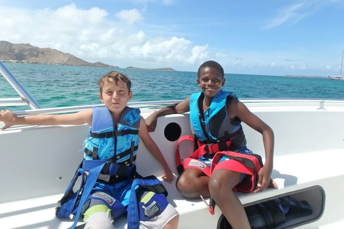 Colorful parasail canopy aloft above the boat during parasailing in St Maarten near Orient Bay