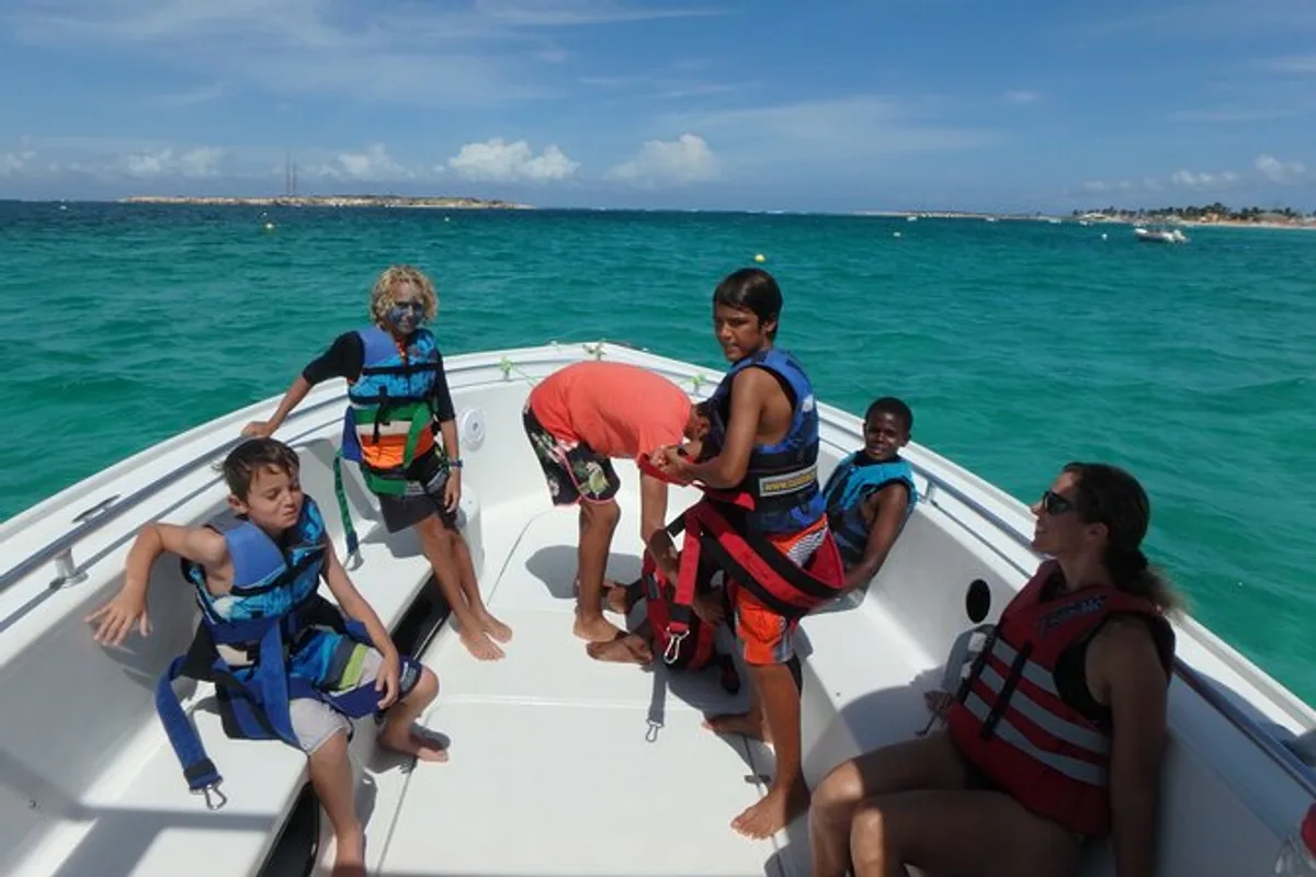 Parasail boat lifting riders off the deck during parasailing in St Maarten over Orient Bay Beach